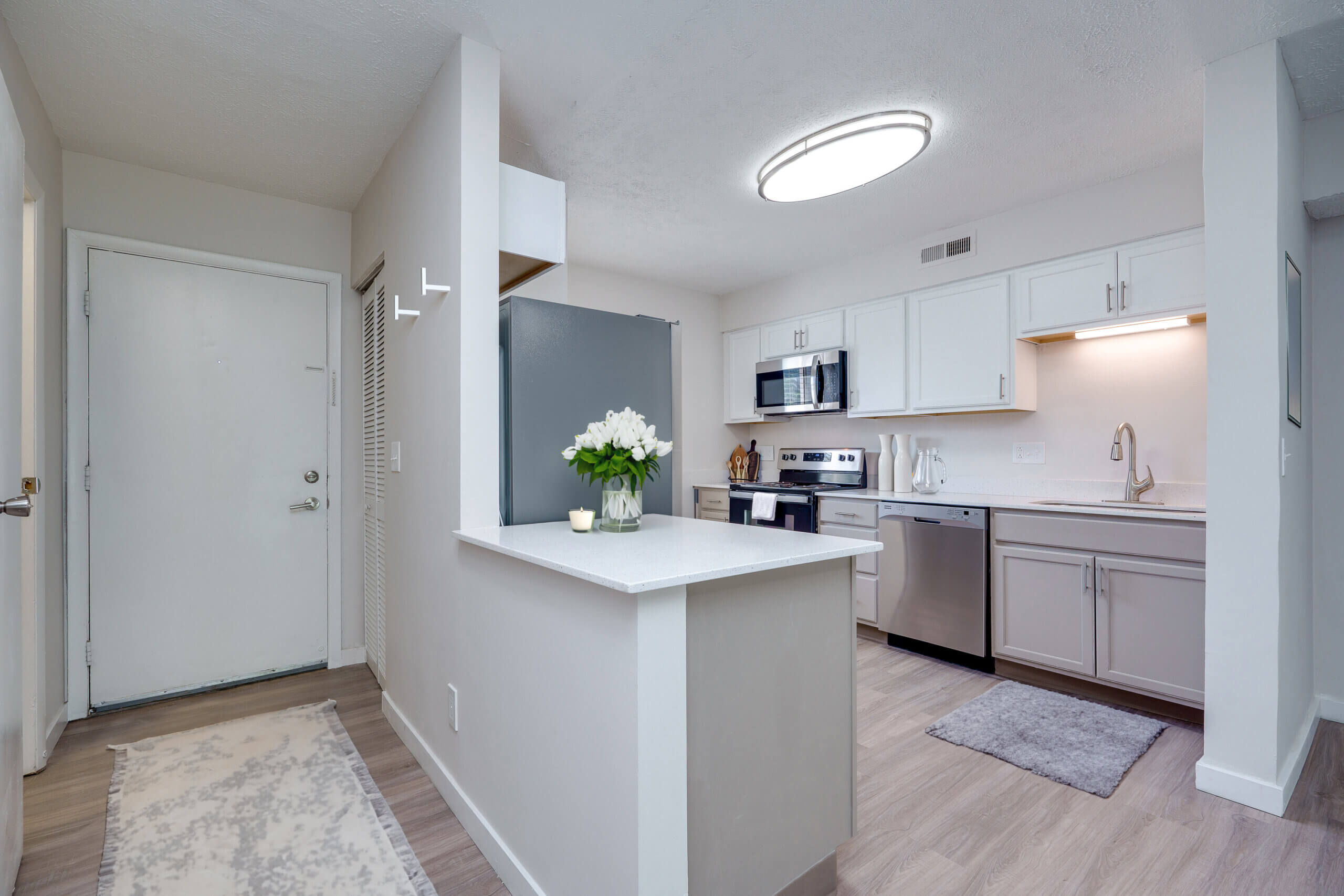 Updated apartment with white kitchen cabinetry